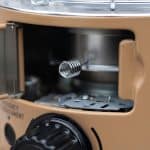 Image of a portable gas stove with a metallic burner and control knob, ideal for camping and outdoor cooking.