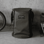 Durable olive green backpack with "Gear Mission" patch, ideal for hiking and commuting.