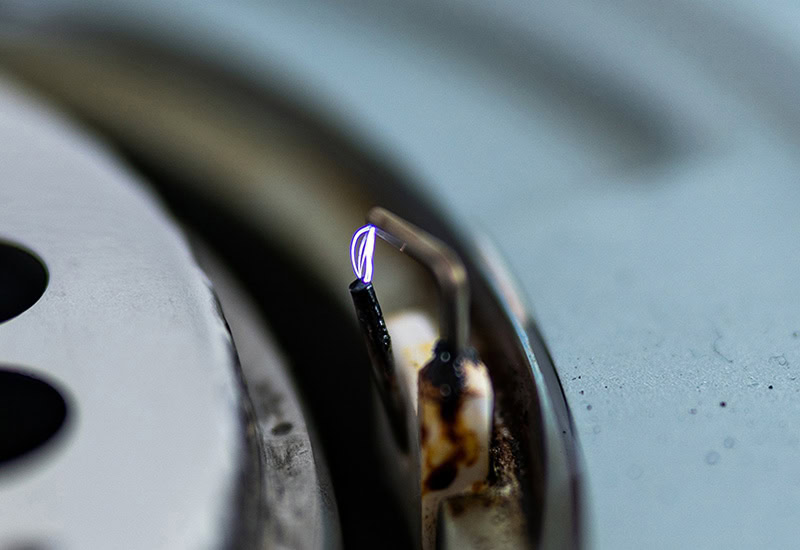 Close-up of a burnt and corroded heating element in a heating appliance.
